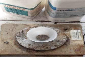 A white plate on a wood surface

Description automatically generated