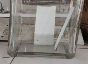 A glass container with a piece of paper in it

Description automatically generated