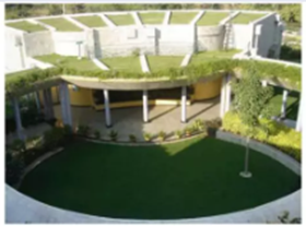 A circular building with a green lawn

AI-generated content may be incorrect.