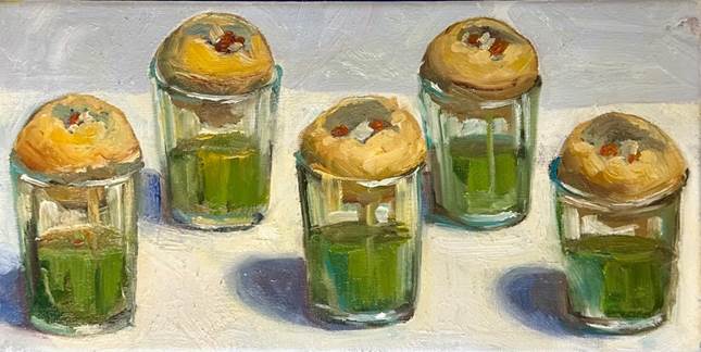 A group of glasses with green liquid

Description automatically generated