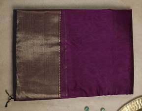 A purple and gold cloth

Description automatically generated