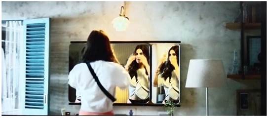 A person looking at herself in a mirror

Description automatically generated with low confidence