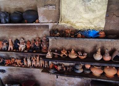 A shelf with clay statues

Description automatically generated