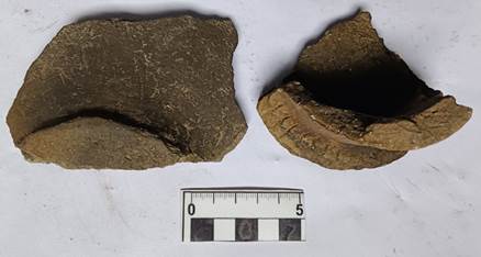 A close-up of a ruler and a piece of clay

Description automatically generated