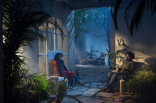 A person and person sitting in a courtyard

Description automatically generated