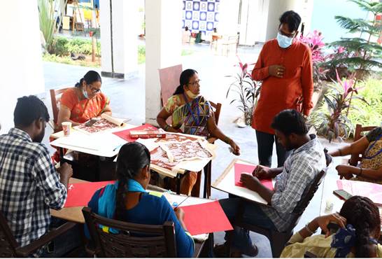 A group of people sitting around a table

Description automatically generated with medium confidence