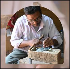 A person working on a stone

Description automatically generated