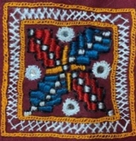 A close-up of a butterfly embroidery

Description automatically generated