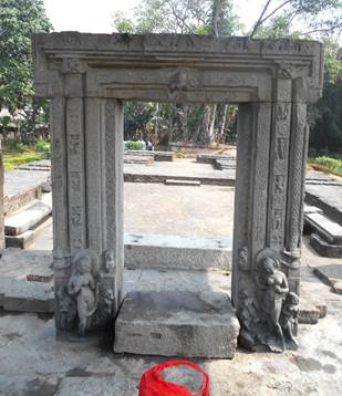 A stone archway with a red sign

Description automatically generated