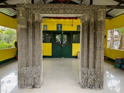 A stone doorway with carvings

Description automatically generated