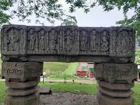 A stone structure with carvings on it

Description automatically generated