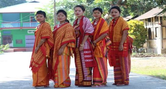 A group of women wearing colorful dresses

Description automatically generated