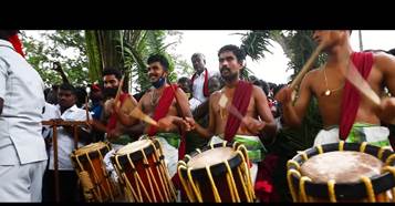 A group of people playing drums

Description automatically generated