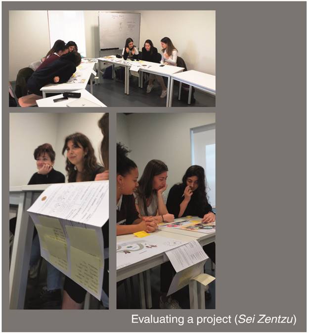 A group of people sitting at desks in a room

Description automatically generated with low confidence