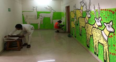 A person painting a wall with deer

Description automatically generated