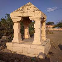A stone structure with pillars

Description automatically generated