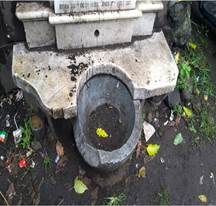 A stone fountain with a hole in it

Description automatically generated