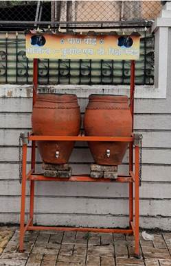 A large clay pots on a stand

Description automatically generated with medium confidence
