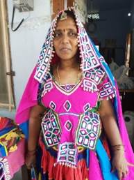 A person in a colorful dress

Description automatically generated with low confidence