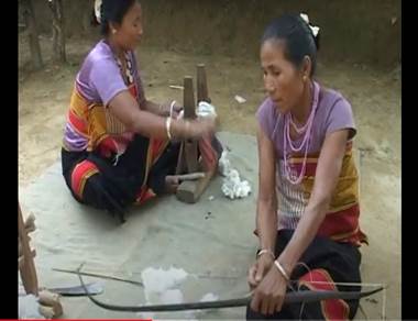 Women sitting on the ground with a long stick

Description automatically generated