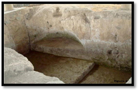A stone wall with a hole in it

Description automatically generated