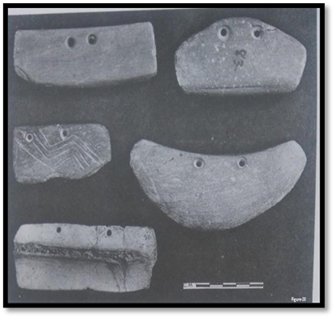 A group of stone objects with holes

Description automatically generated